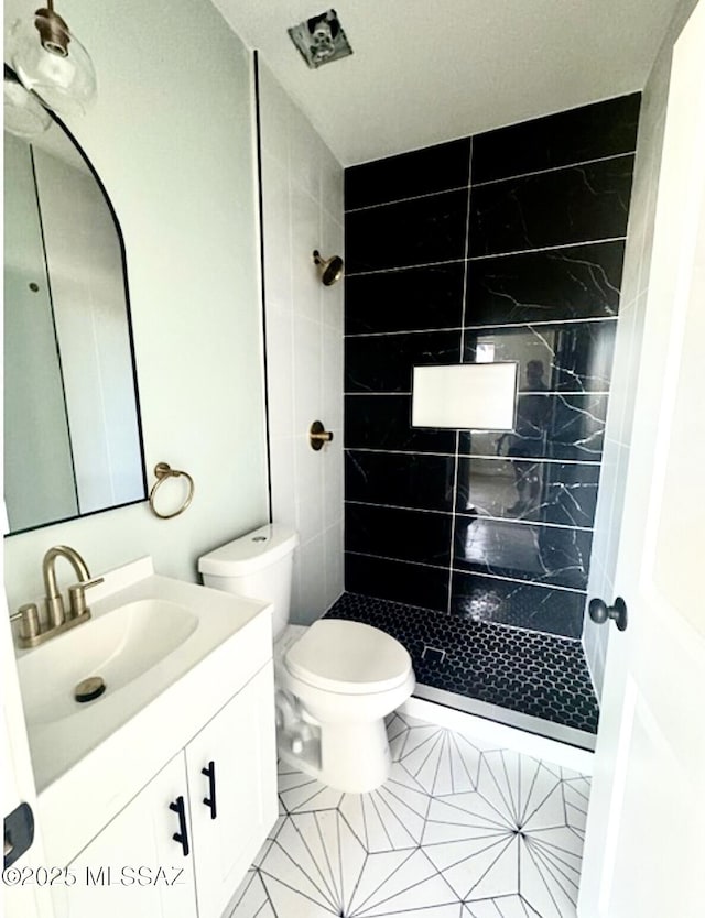 full bathroom with vanity, tile patterned flooring, toilet, and a shower stall