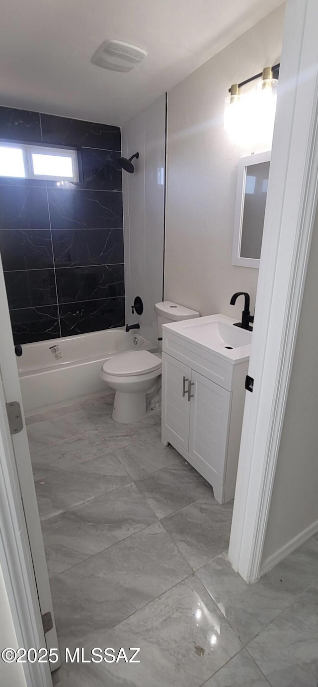bathroom with toilet, bathing tub / shower combination, marble finish floor, and vanity
