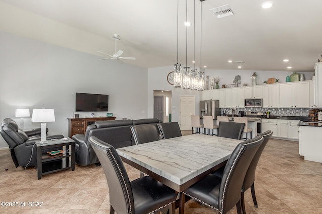 dining room featuring vaulted ceiling and ceiling fan