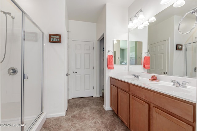 bathroom with tile patterned floors, vanity, and a shower with shower door