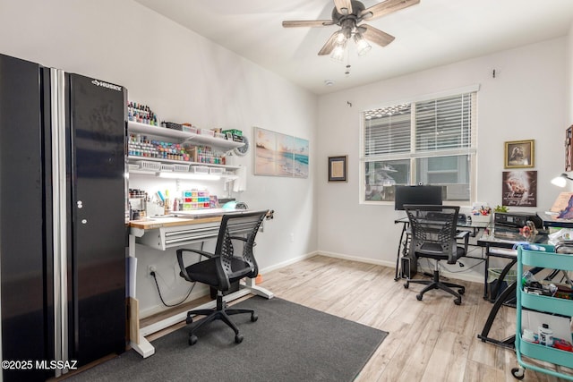 office with ceiling fan and light hardwood / wood-style flooring