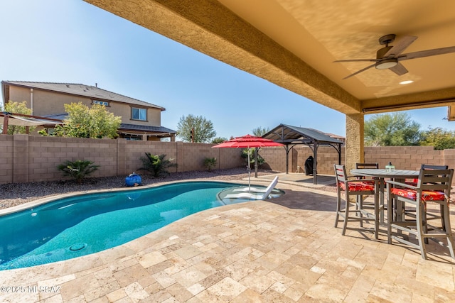 view of pool with a gazebo, ceiling fan, and a patio