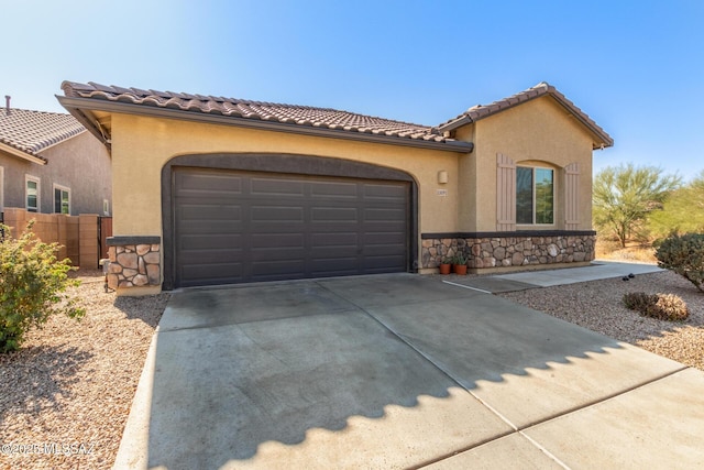 mediterranean / spanish-style home with a garage