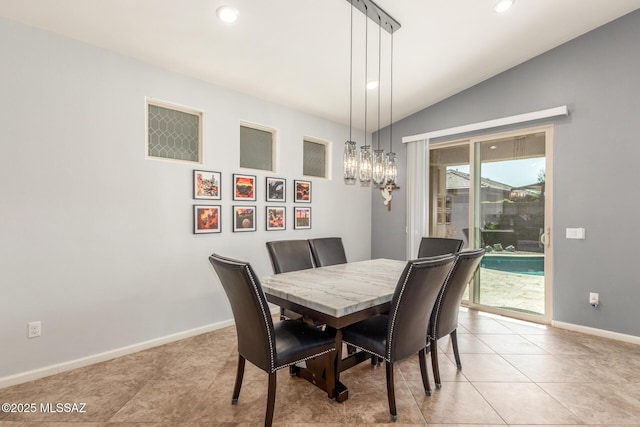 dining area featuring light tile patterned flooring, lofted ceiling, and a notable chandelier