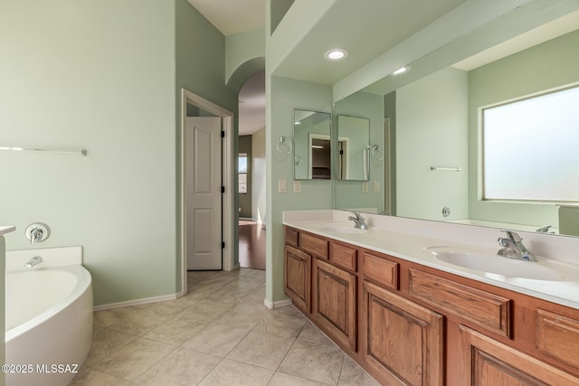 bathroom featuring vanity, a bathtub, and tile patterned floors