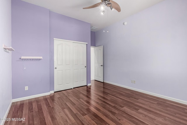 unfurnished bedroom featuring dark hardwood / wood-style flooring, a closet, and ceiling fan