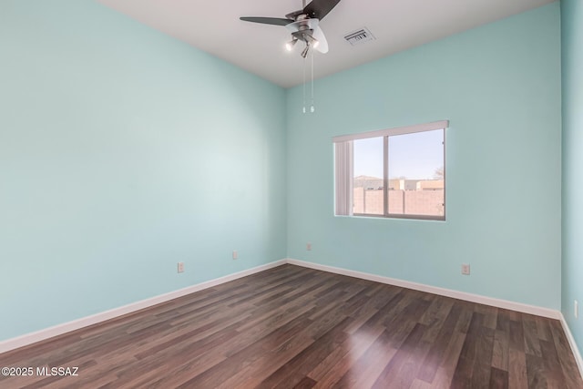 empty room featuring dark hardwood / wood-style floors and ceiling fan