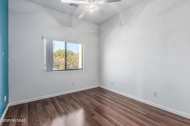 empty room with dark wood-type flooring and ceiling fan