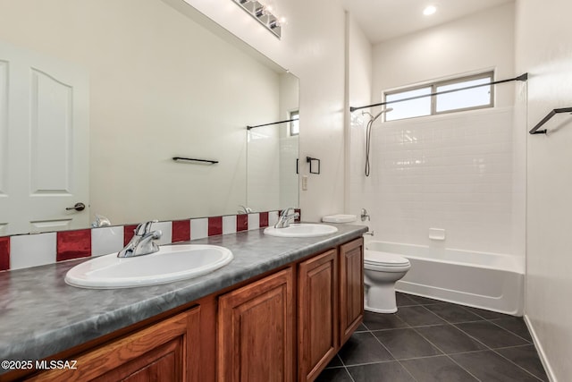 full bathroom featuring tile patterned flooring, tiled shower / bath, vanity, and toilet