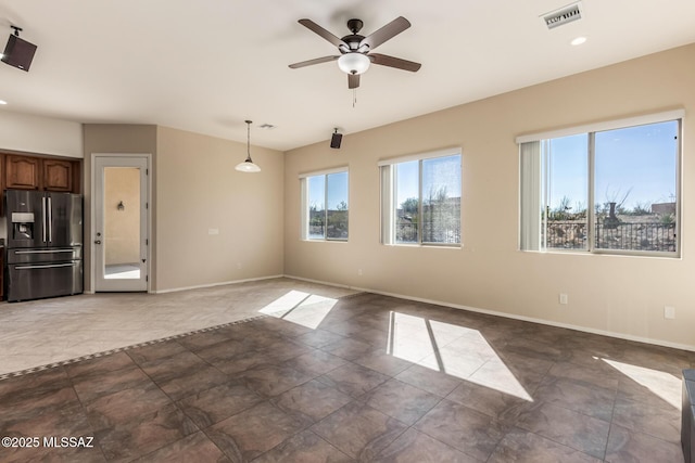 unfurnished living room featuring ceiling fan