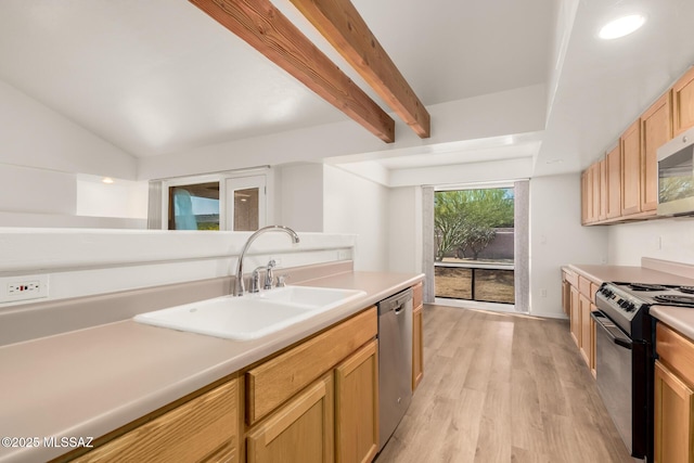 kitchen featuring appliances with stainless steel finishes, sink, vaulted ceiling with beams, and light wood-type flooring