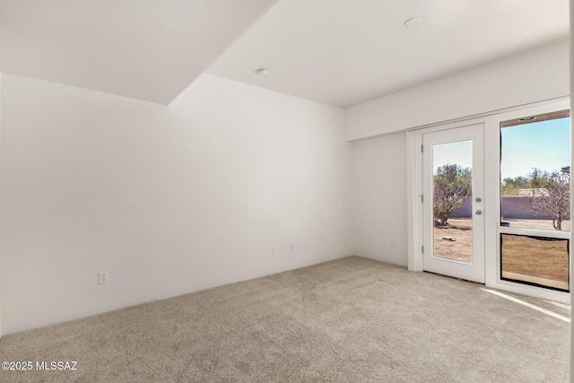 unfurnished room featuring french doors and light colored carpet