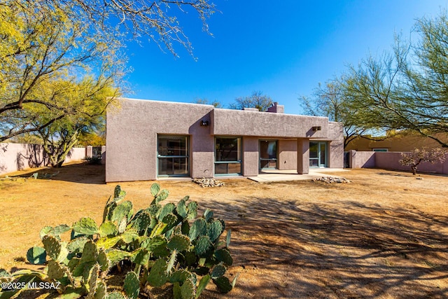 pueblo-style home featuring a patio area