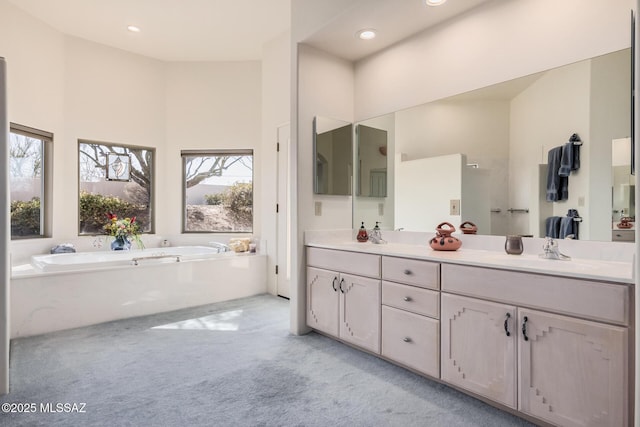 bathroom featuring a tub to relax in and vanity