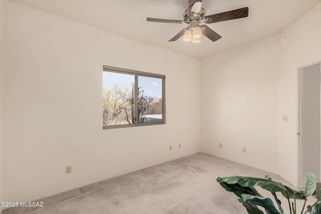 unfurnished room with light colored carpet and ceiling fan