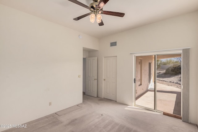 spare room with light carpet and ceiling fan