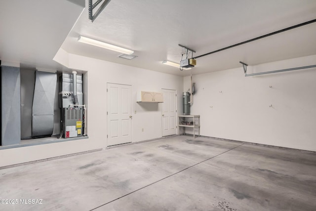 garage with a garage door opener and water heater