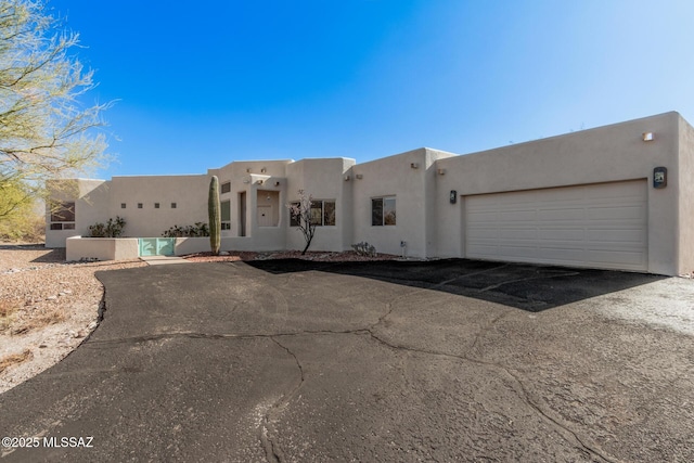 adobe home featuring a garage