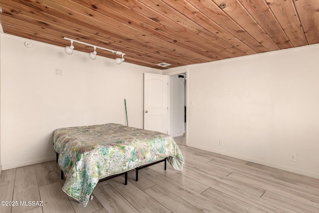 bedroom featuring wood ceiling and light wood-type flooring