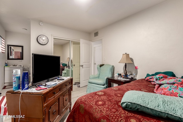 bedroom featuring a closet and light hardwood / wood-style flooring