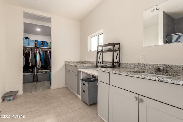 kitchen featuring sink and light stone counters