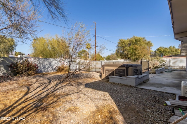 view of yard featuring a hot tub and a patio