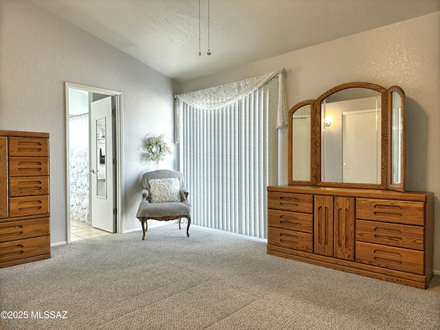 sitting room featuring light carpet and vaulted ceiling