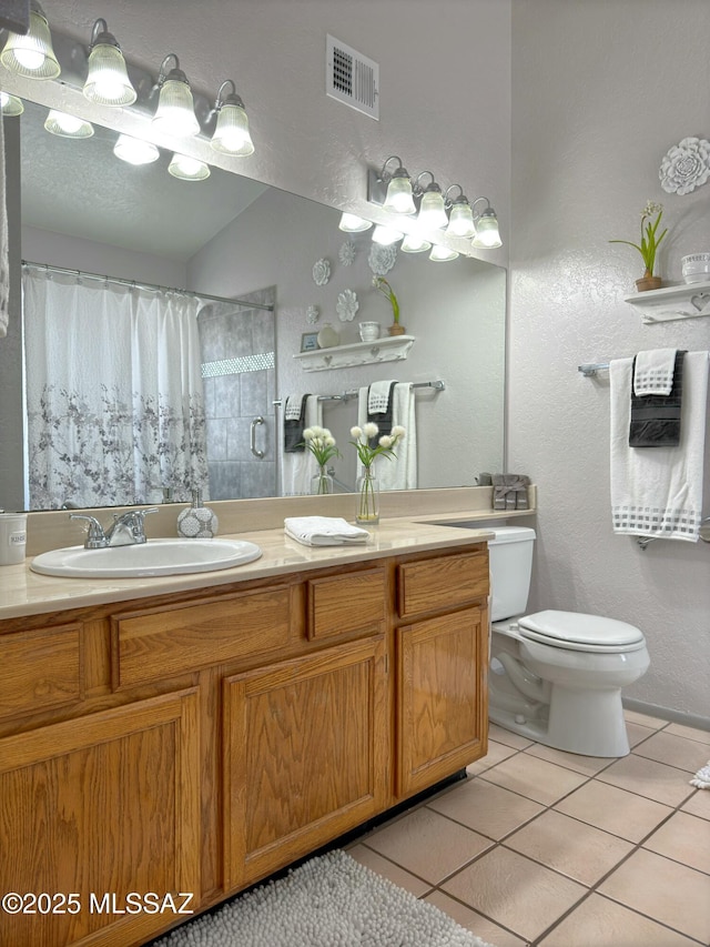 bathroom with a shower with curtain, tile patterned floors, toilet, and vanity