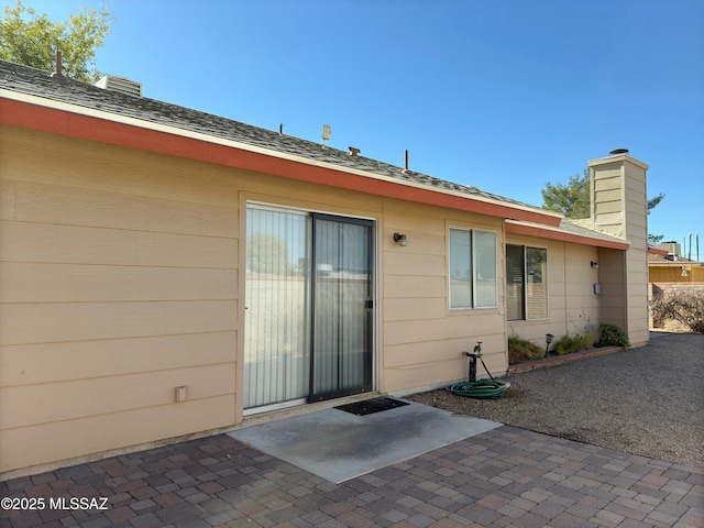 back of property with a patio