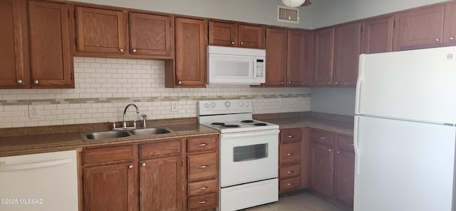 kitchen featuring light tile patterned flooring, sink, white appliances, and decorative backsplash