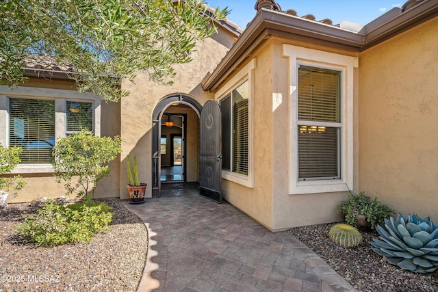 view of exterior entry with a patio