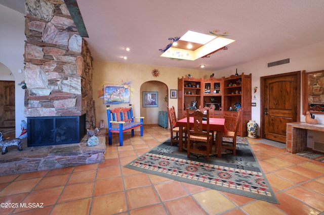 925 N Rancho Del Jefe Loop, Tucson, AZ 85748 - dining room featuring arched walkways, a skylight, and tile patterned flooring