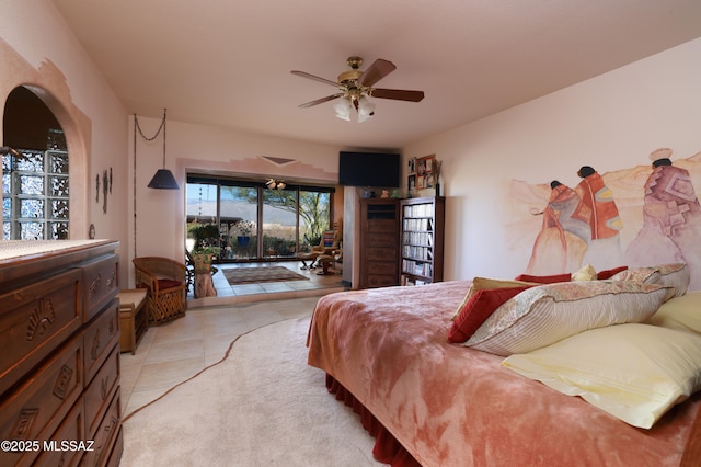 925 N Rancho Del Jefe Loop, Tucson, AZ 85748 - bedroom featuring access to exterior, light tile patterned floors, arched walkways, and a ceiling fan
