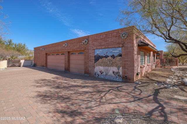 925 N Rancho Del Jefe Loop, Tucson, AZ 85748 - view of property exterior featuring brick siding and a garage