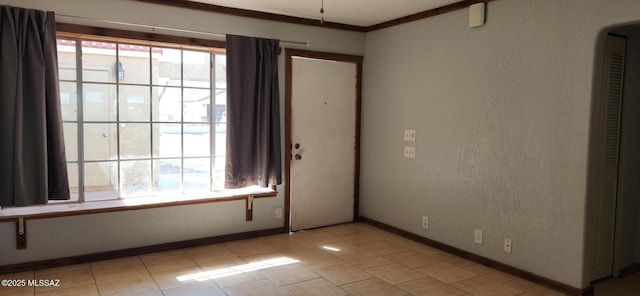 empty room with crown molding and plenty of natural light