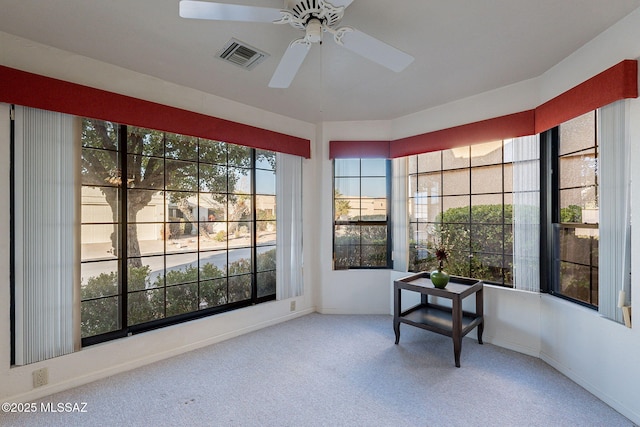 sunroom / solarium featuring ceiling fan