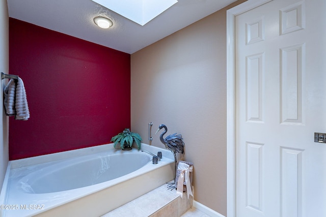 bathroom featuring a skylight and a tub