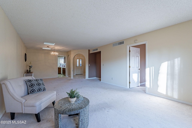 living room with light carpet and a textured ceiling