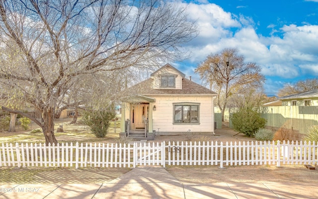 view of front of home featuring roof with shingles and a fenced front yard