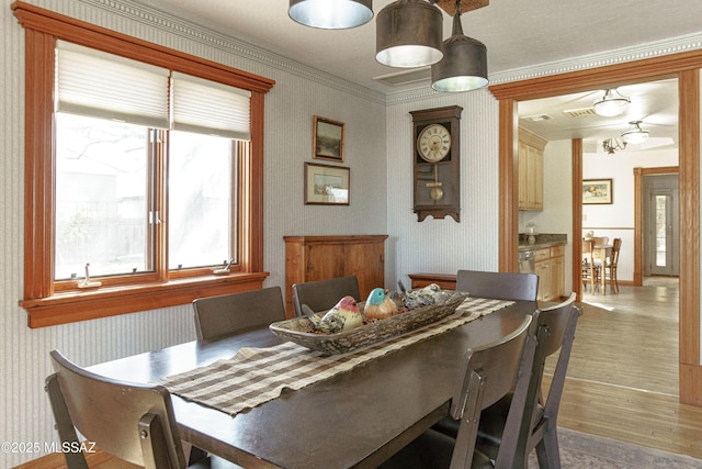 dining room featuring crown molding and hardwood / wood-style flooring