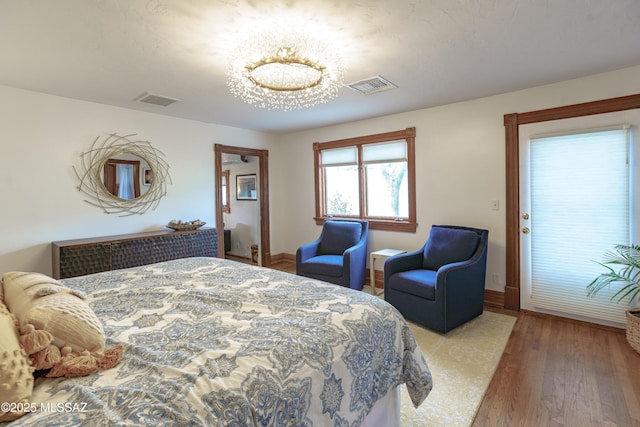 bedroom with hardwood / wood-style flooring