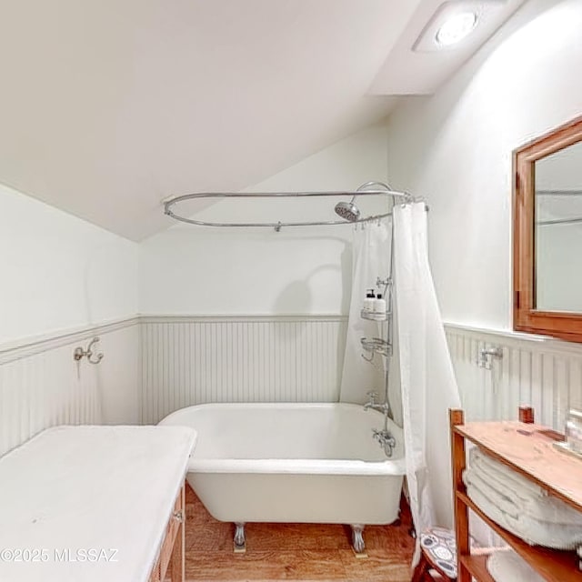 bathroom with vanity, lofted ceiling, and shower / bath combo