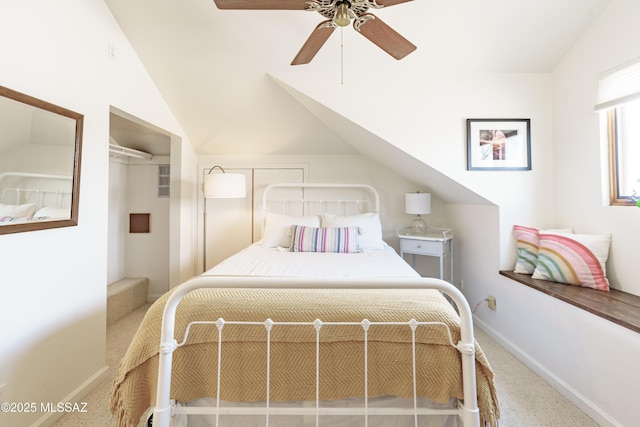 carpeted bedroom with vaulted ceiling and ceiling fan