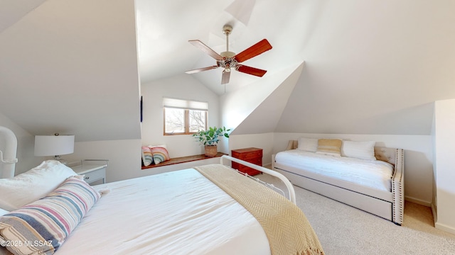 carpeted bedroom with ceiling fan and vaulted ceiling