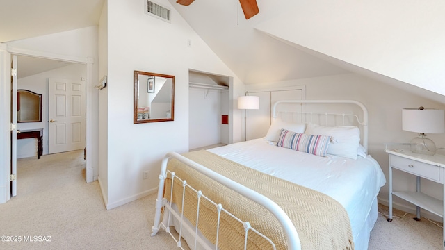 bedroom with lofted ceiling, light colored carpet, ceiling fan, and a closet