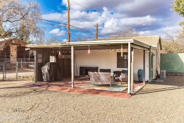 rear view of house featuring an outdoor living space and a patio area