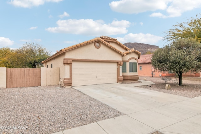 view of front facade featuring a garage and a mountain view