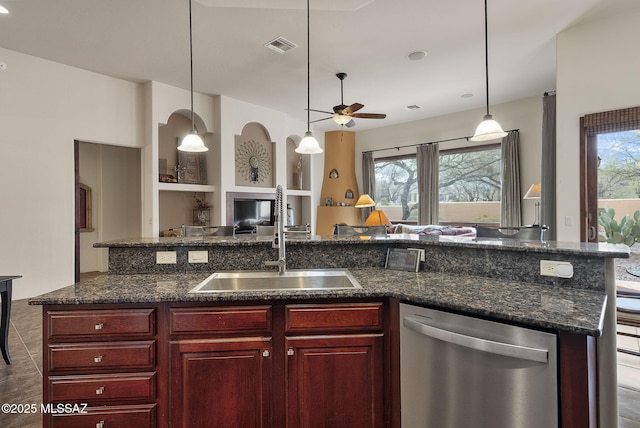 kitchen featuring dishwasher, a sink, open floor plan, a ceiling fan, and dark brown cabinets