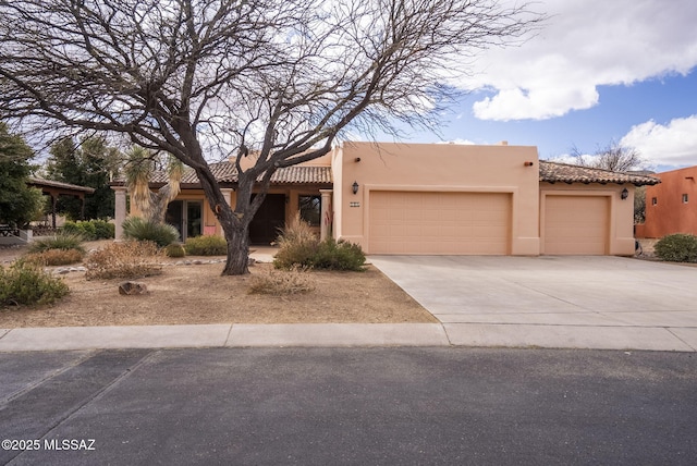 pueblo-style home with a garage