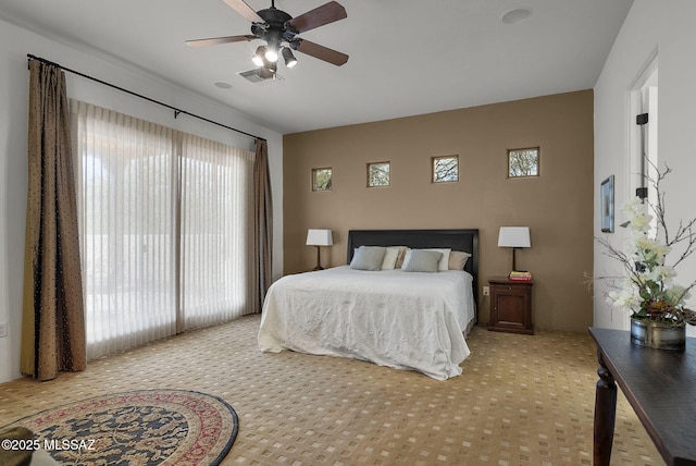bedroom featuring visible vents, ceiling fan, and carpet